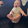 baby, infant, smiling, couch, bib, happy, indoor, person, child, furniture, blanket, hand, foot, arm, clothing, seat, texture, light, expression, playful