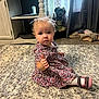 toddler, child, carpet, indoor, curtains, slippers, dress, footwear, floor, furniture, toy, statue, person, hair_bow, expression, thumbs_up, blue_eyes, home_interior, curly_hair, sitting