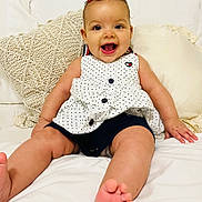 Everly joined the competition — help win amazing prizes! baby, babylaughing, bed, bedroom, clothing, couch, cushion, face, furniture, happy, head, homedecor, indoors, laughing, person, photography, portrait, room, shorts, sitting