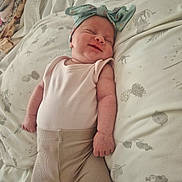 Dottie joined the competition — help win amazing prizes! baby, bed, blanket, bow, child, clothing, cute, fabric, headband, indoors, infant, newborn, pattern, peaceful, pillow, portrait, relaxing, sleeping, smile, soft