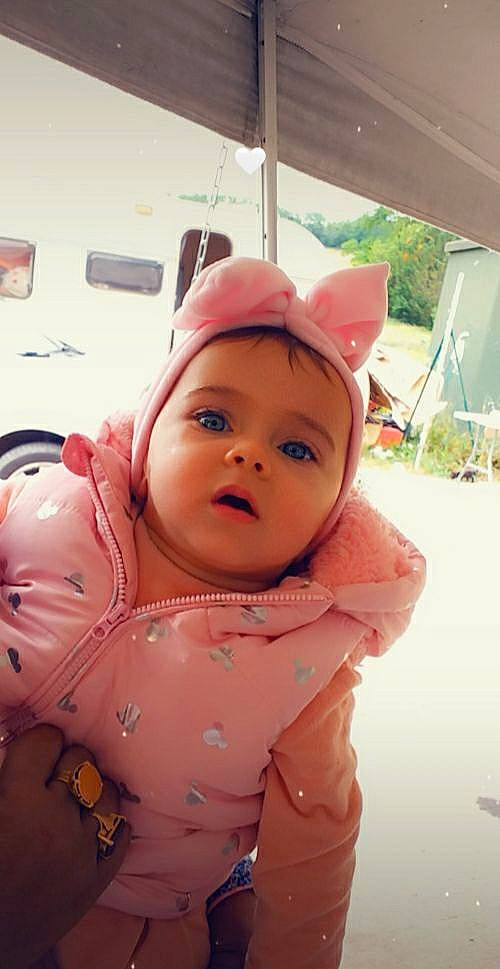 Tenessy participe au concours pour gagner de l'argent avec cette photo : baby, baby_toddler_clothing, cheek, child, fashion_accessory, flooring, fun, happy, headgear, lip, magenta, nose, peach, person, personal_protective_equipment, pink, plant, skin, sleeve, toddler