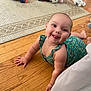 Kaylonni joined the competition — help win amazing prizes! baby, child, crawling, smiling, happy, floor, wooden_floor, rug, toy_car, soccer_ball, plush_toy, green_outfit, indoor, cute, person, infant, playtime, home, bright, colorful