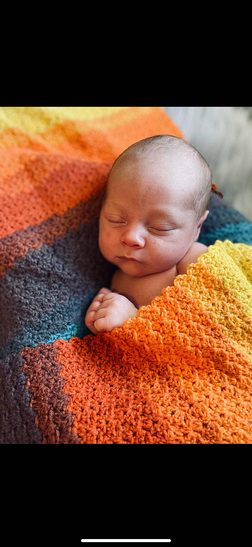 Jaxon is registered to the contest to win money with this photo: baby, baby_toddler_clothing, cheek, child, chin, close_up, comfort, finger, flooring, fur, knit_cap, linens, magenta, nose, orange, pattern, person, skin, toddler, wool