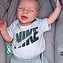 baby, infant, smiling, sleeping, nike, clothing, shorts, tshirt, pacifier, cushion, carrier, comfort, relaxation, child, person, happy, cute, portrait, indoors, young