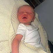 Teddie joined the competition — help win amazing prizes! newborn, baby, sleeping, blanket, knit, white_clothing, arm, hand, indoor, resting, cozy, person, infant, peaceful, soft_texture, home_interior, furniture, shelf, portrait, relaxation