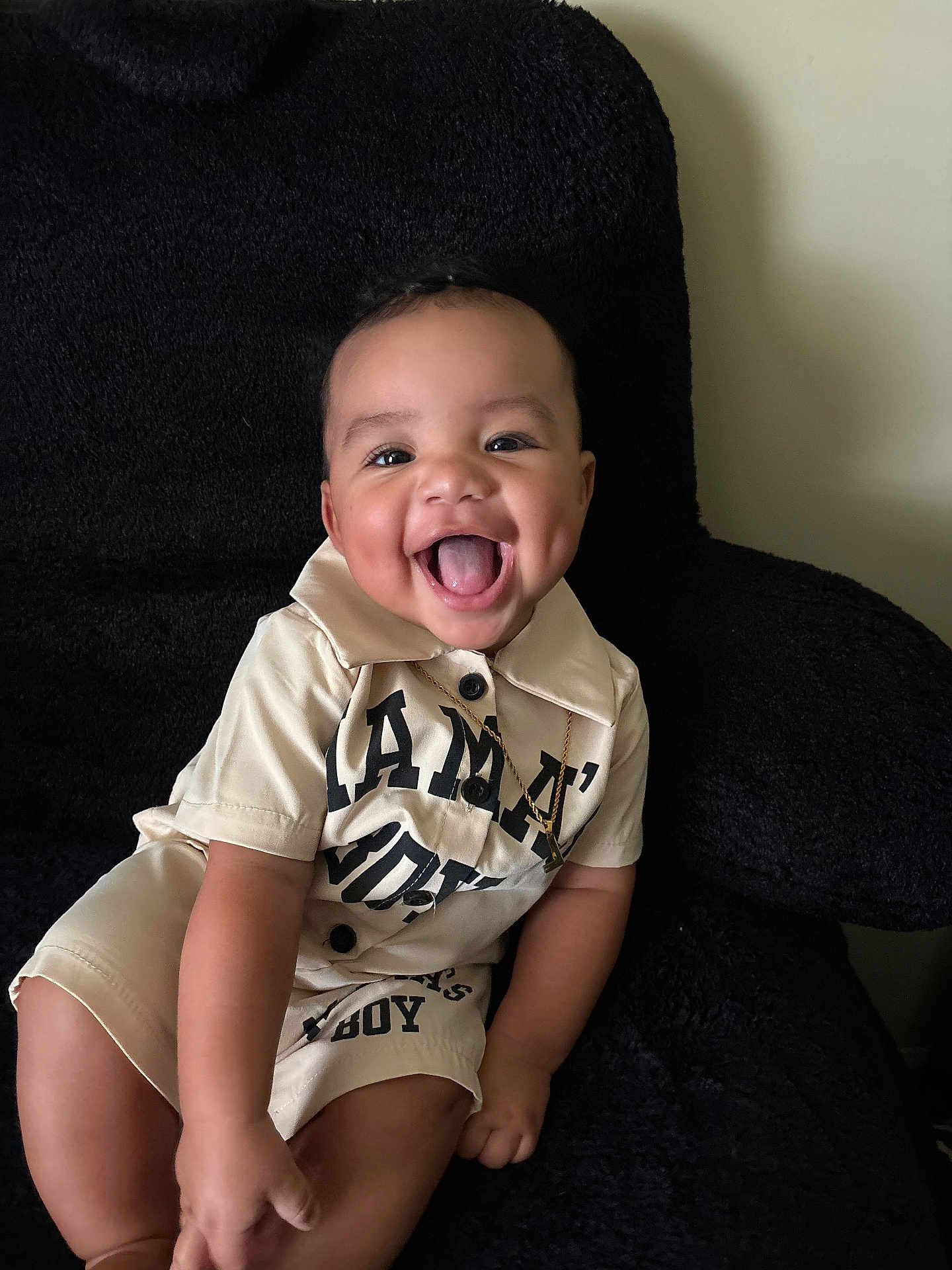 Legend joined the competition — help win amazing prizes! baby, child, smiling, happy, tongue_out, dimple, sitting, chair, plush, clothing, necklace, black, beige, indoor, portrait, cute, person, infant, joyful, fashion