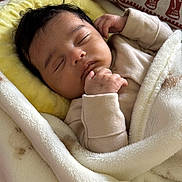 Leandra joined the competition — help win amazing prizes! baby, sleeping, blanket, pillow, elephant_pattern, soft_texture, infant, cozy, peaceful, child, wrapped, closeup, indoors, cute, warm, resting, peace, face, hand, clothing