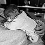 Liam participe au concours pour gagner de l'argent avec cette photo : baby, black_and_white, caring, close_up, clothing, comfort, cozy, hand, human, indoor, infant, knitted_sweater, newborn, pacifier, person, portrait, resting, sleeping, soft_lighting, tender