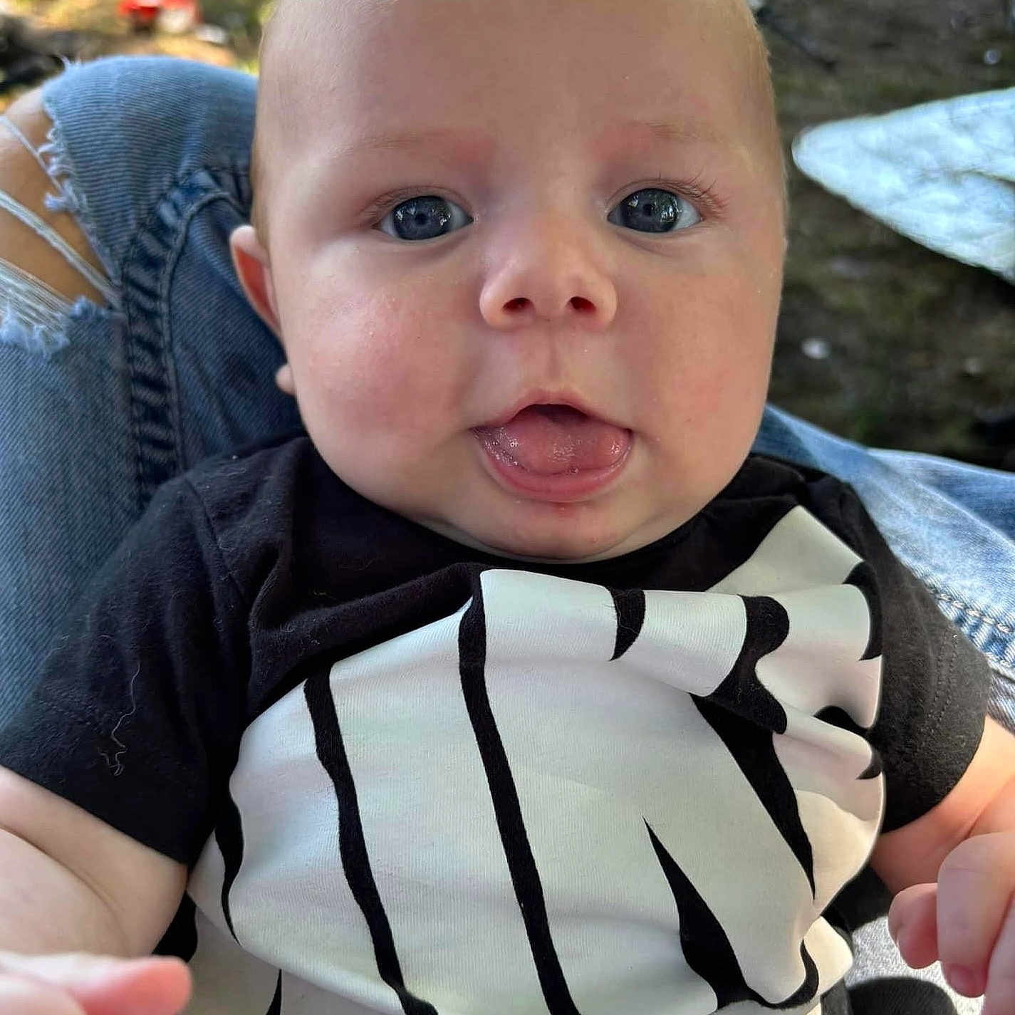 Leighton is registered to the contest to win money with this photo: baby, blonde, bodypart, clothing, face, finger, frown, hair, hand, happy, head, jeans, pants, person, photography, portrait, sad, selfie, sitting, t_shirt