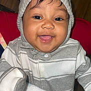 Darian is registered to the contest to win money with this photo: baby, child, smiling, face, knit_hat, striped_clothing, blanket, indoor, happy, cute, portrait, cozy, warm_clothing, sitting, toddler, furniture, purse, closeup, person, infant