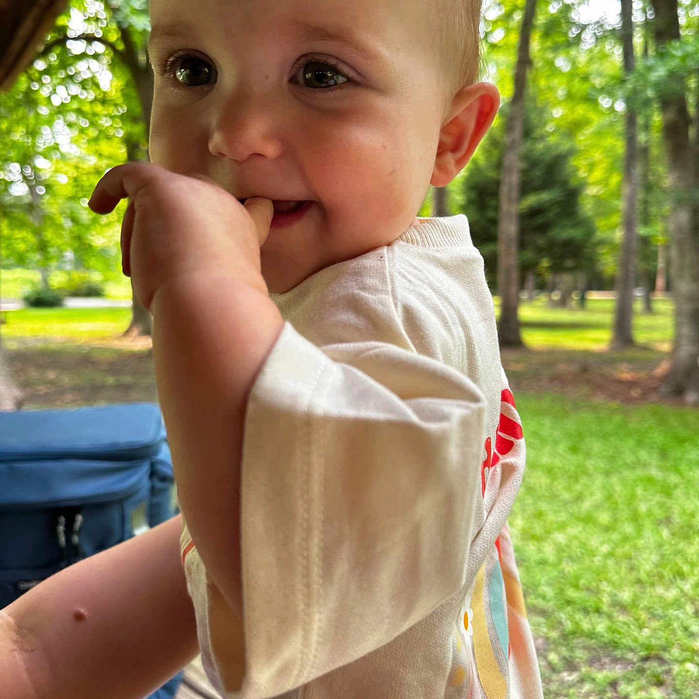 Hannah Kay joined the competition — help win amazing prizes! baby, child, closeup, clothing, cute, daylight, face, fingers, grass, greenery, hand, holding, nature, outdoor, park, person, portrait, smile, trees, young