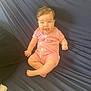 baby, blue_eyes, pink_onesie, smiling, wet_hair, couch, infant, happy, sitting, child, young, indoor, clothing, face, person, cute, skin, furniture, portrait, young_child