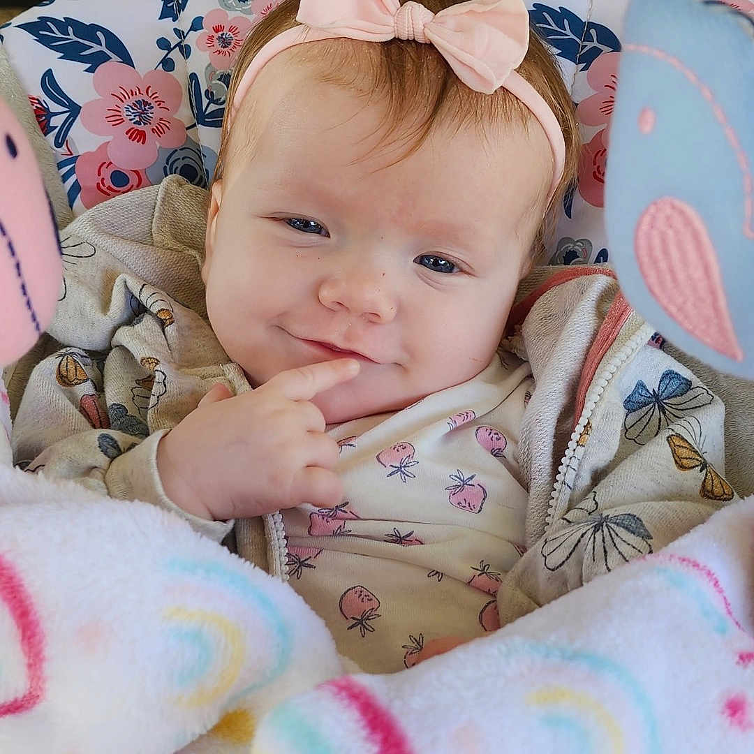 Layla is registered to the contest to win money with this photo: accessories, baby, bed, blanket, clothing, cushion, dress, face, furniture, happy, head, homedecor, machine, newborn, person, photography, portrait, quilt, sleeping, wheel