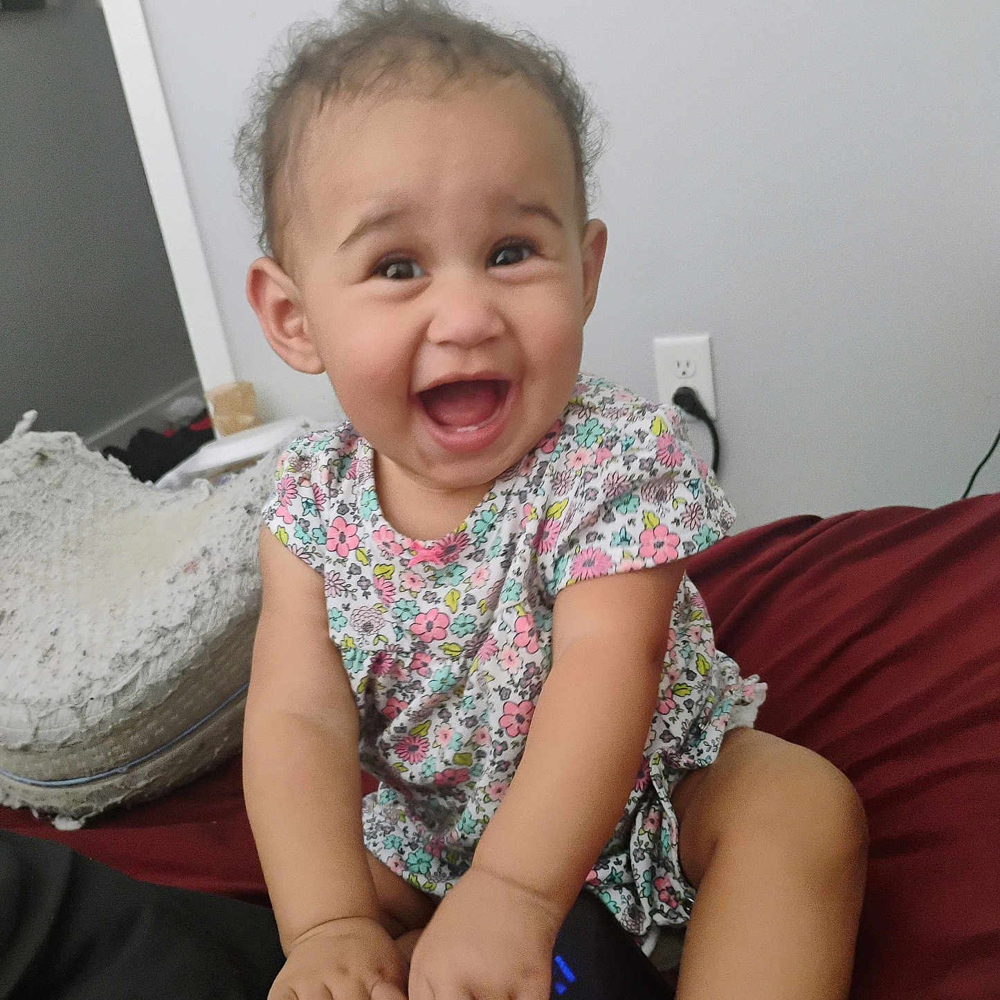 Kehlani joined the competition — help win amazing prizes! baby, bed, casual, child, curly_hair, cute, face, floral_dress, hands, happy, home, indoor, joyful, person, power_outlet, room, sitting, smiling, sneaker, tablet