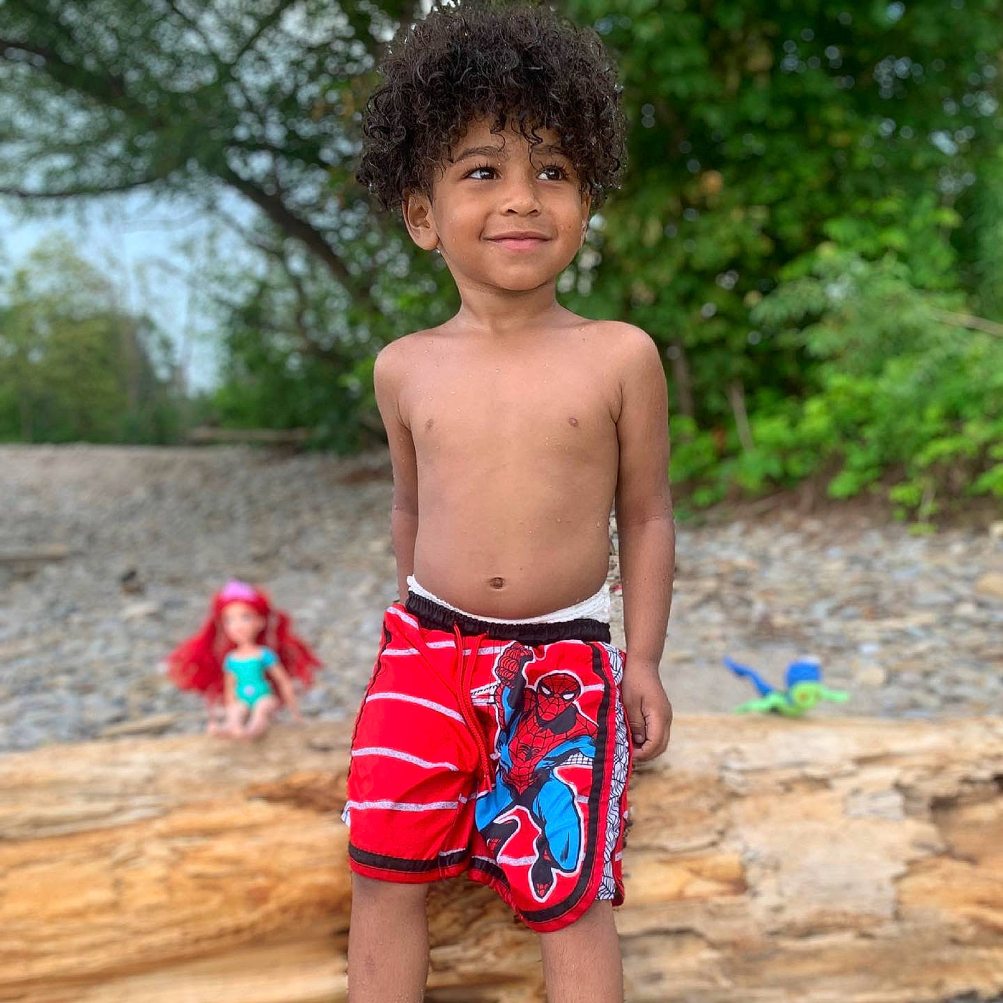 Jaden is registered to the contest to win money with this photo: abdomen, barechested, board_short, chest, cool, face, happy, head, joy, leisure, muscle, neck, people_in_nature, person, smile, summer, toddler, tree, trunk, trunks
