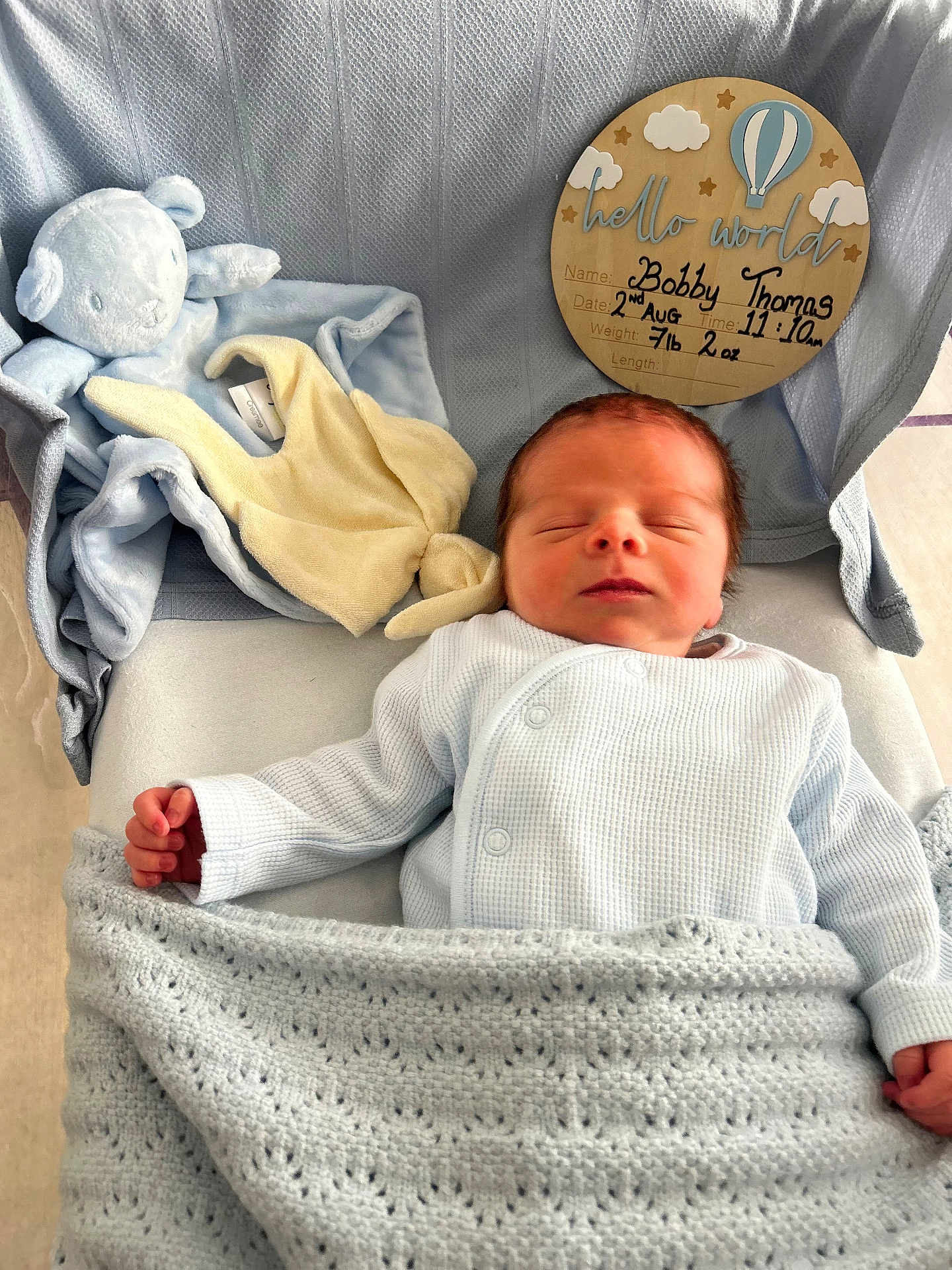 Bobby is registered to the contest to win money with this photo: baby, newborn, blanket, sleeping, plush_toy, blue, clothing, infant, bed, announcement, sign, soft, cute, peaceful, wrapped, hand, face, indoors, resting, toddler