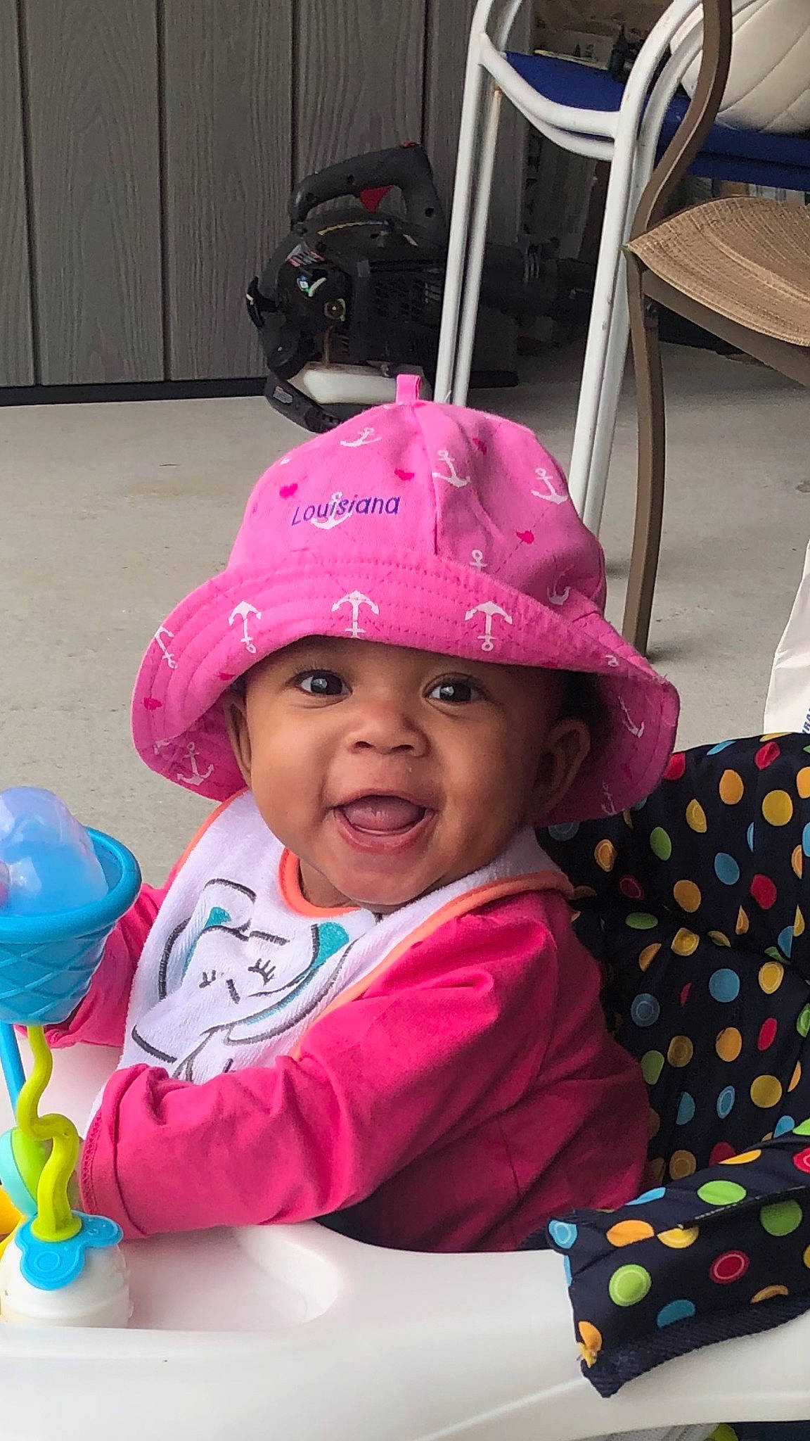 Halo is registered to the contest to win money with this photo: baby_toddler_clothing, baseball_cap, cap, child, fashion_accessory, fun, happy, headwear, helmet, leisure, magenta, pattern, person, personal_protective_equipment, pink, recreation, sleeve, smile, sun_hat, t_shirt