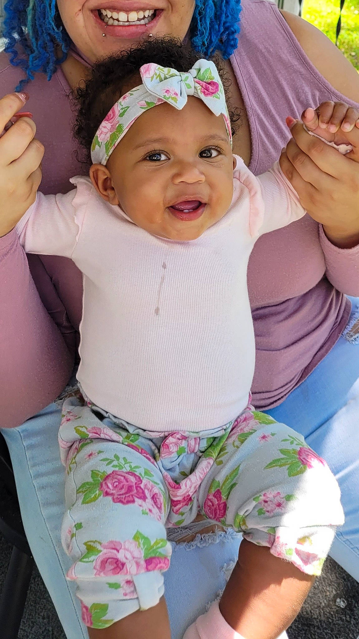 Halo is registered to the contest to win money with this photo: baby, baby_toddler_clothing, face, facial_expression, finger, gesture, green, hand, happy, head, headwear, human_body, person, pink, purple, skin, sleeve, smile, textile, violet