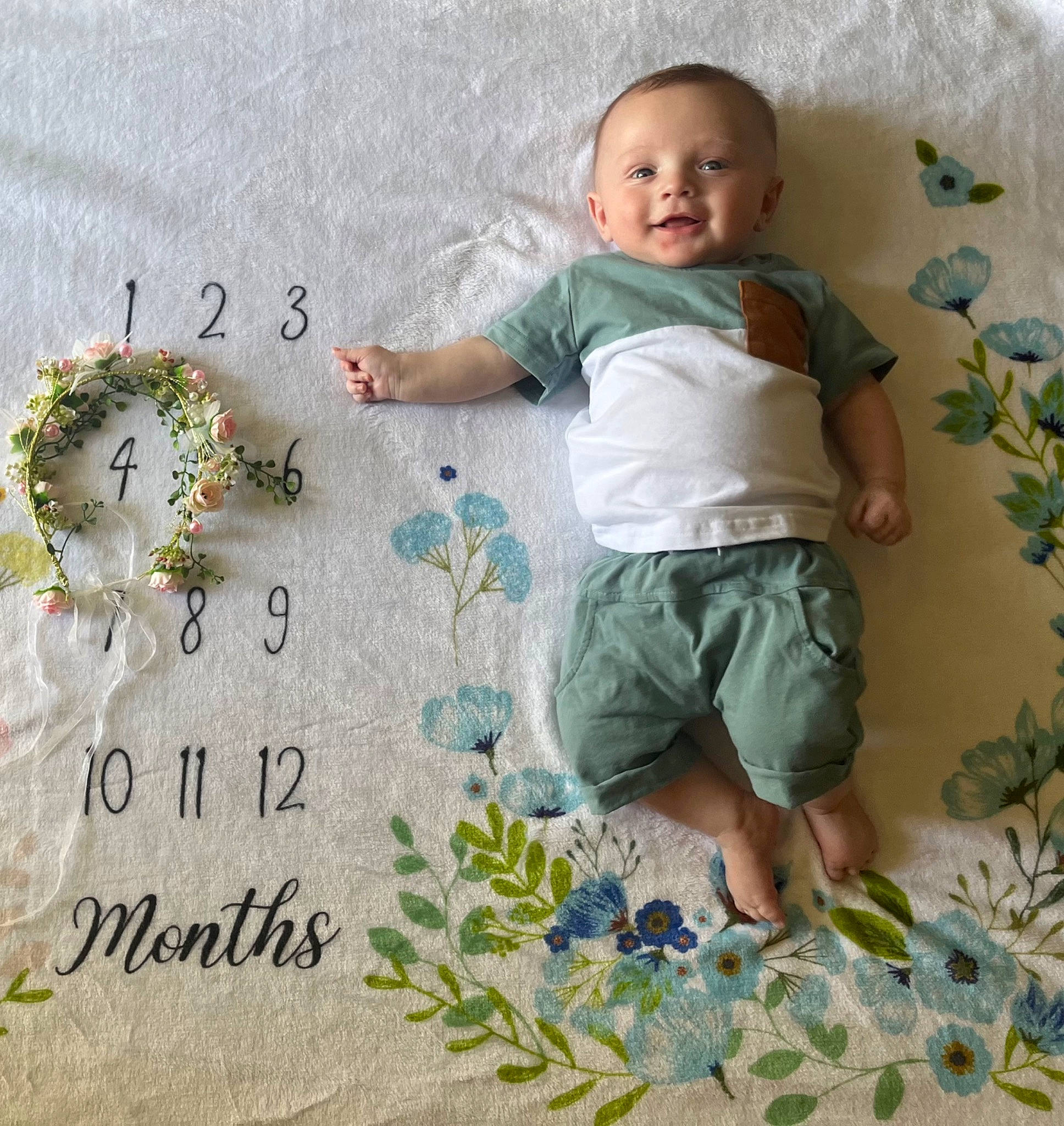 Jace is registered to the contest to win money with this photo: baby, baby_toddler_clothing, child, comfort, face, font, grass, happy, leaf, linens, military_camouflage, paper, pattern, people_in_nature, person, sleeve, smile, t_shirt, textile, toddler