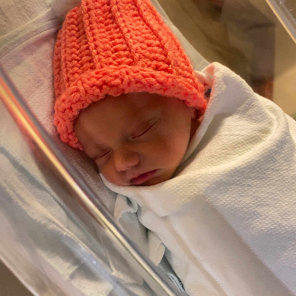 Stetson is registered to the contest to win money with this photo: baby, bassinet, blanket, child, cozy, cute, hat, hospital, indoor, infant, knitted_hat, newborn, pacifier, peaceful, pom_pom, portrait, resting, sleeping, soft, wrapped