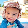 Milo participe au concours pour gagner de l'argent avec cette photo : baby, child, smiling, water, splash, pool, hat, blue_clothing, sunny, outdoor, hand, person, happy, face, playful, summer, daytime, building, swimwear, skin