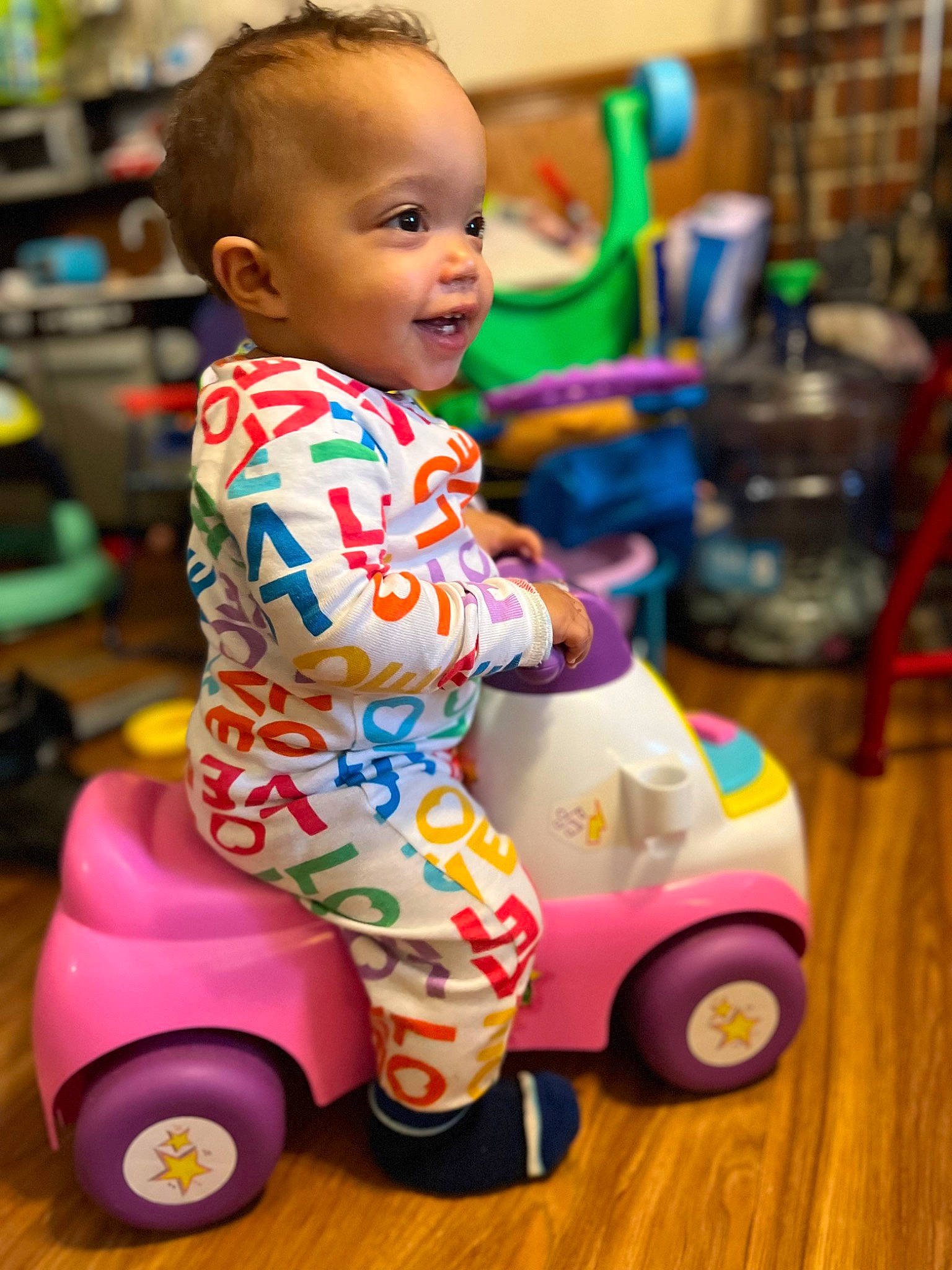 Journee is registered to the contest to win money with this photo: baby, baby_products, baby_toddler_clothing, baby_toys, child, flooring, fun, happy, head, motor_vehicle, person, play, riding_toy, skin, smile, snapshot, tire, toddler, toy, vehicle