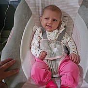 Magnolia is registered to the contest to win money with this photo: baby, baby_girl, baby_seat, carpet, child, clothing, comfort, cushion, cute, floor, hand, indoor, infant, person, pink_clothing, seat, smile, socks, straps, wall_outlet