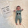 baby, baby_clothes, blanket, cute, face, feet, hands, indoor, infant, letterboard, lying_down, mickey_mouse, milestone_board, neutral_expression, newborn, nursery, overalls, photography, portrait, soft_texture