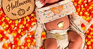 Wyatt is registered to the contest to win money with this photo: newborn, baby, infant, sleeping, halloween, candy_corn, hospital, medical_tubes, monitoring, pacifier, swaddle, blanket, wooden_sign, pumpkin, portrait, top_down, festive, indoor, face, parenting