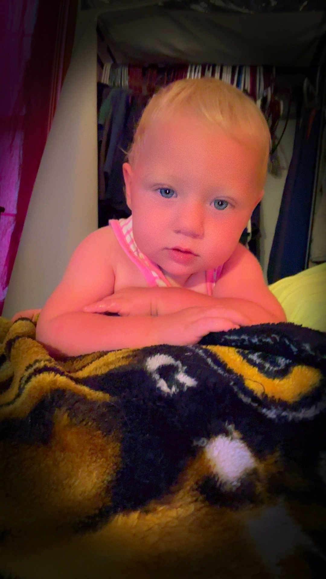 Faith is registered to the contest to win money with this photo: toddler, child, baby, blanket, indoor, face, blue_eyes, curious, portrait, clothing, arms, leaning, soft_light, bedroom, furniture, home, skin, hair, expression, cozy