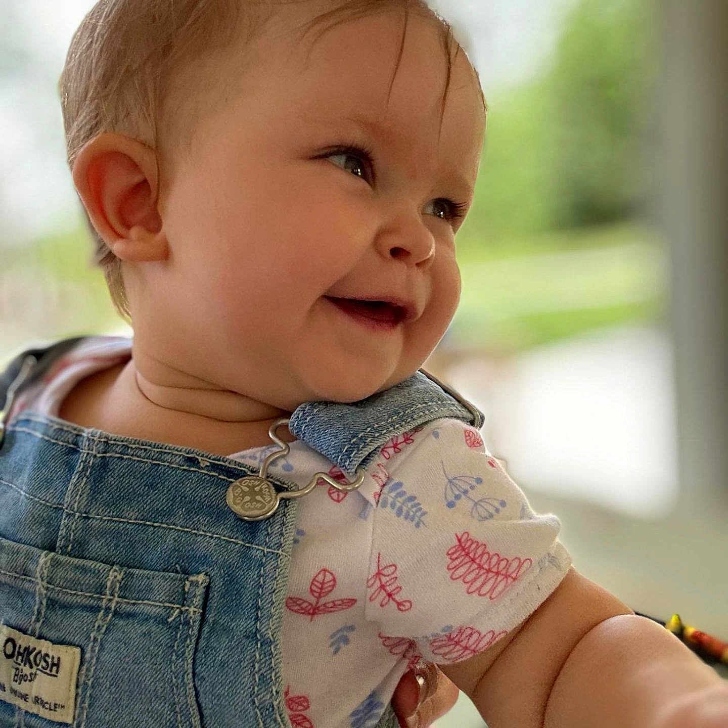 Emilia joined the competition — help win amazing prizes! accessories, baby, babylaughing, brownhair, clothing, coat, face, hair, happy, head, jacket, jeans, pants, person, photography, portrait, sitting, sleeve, smile, vest