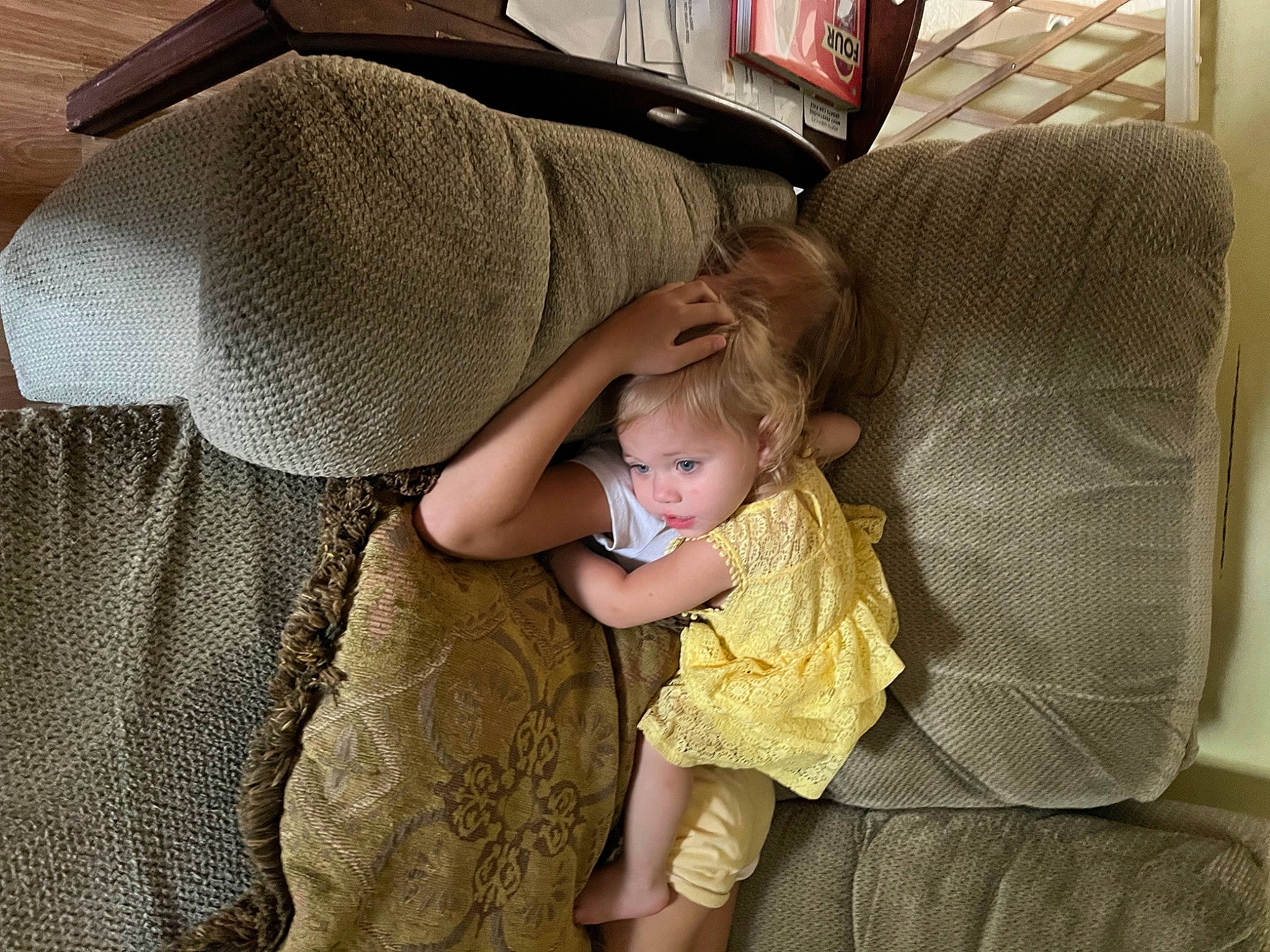 Mia is registered to the contest to win money with this photo: baby, baby_products, baby_toddler_clothing, car_seat, child, comfort, couch, flooring, foot, hat, human_leg, lap, linens, person, product, room, sitting, sock, textile, toddler