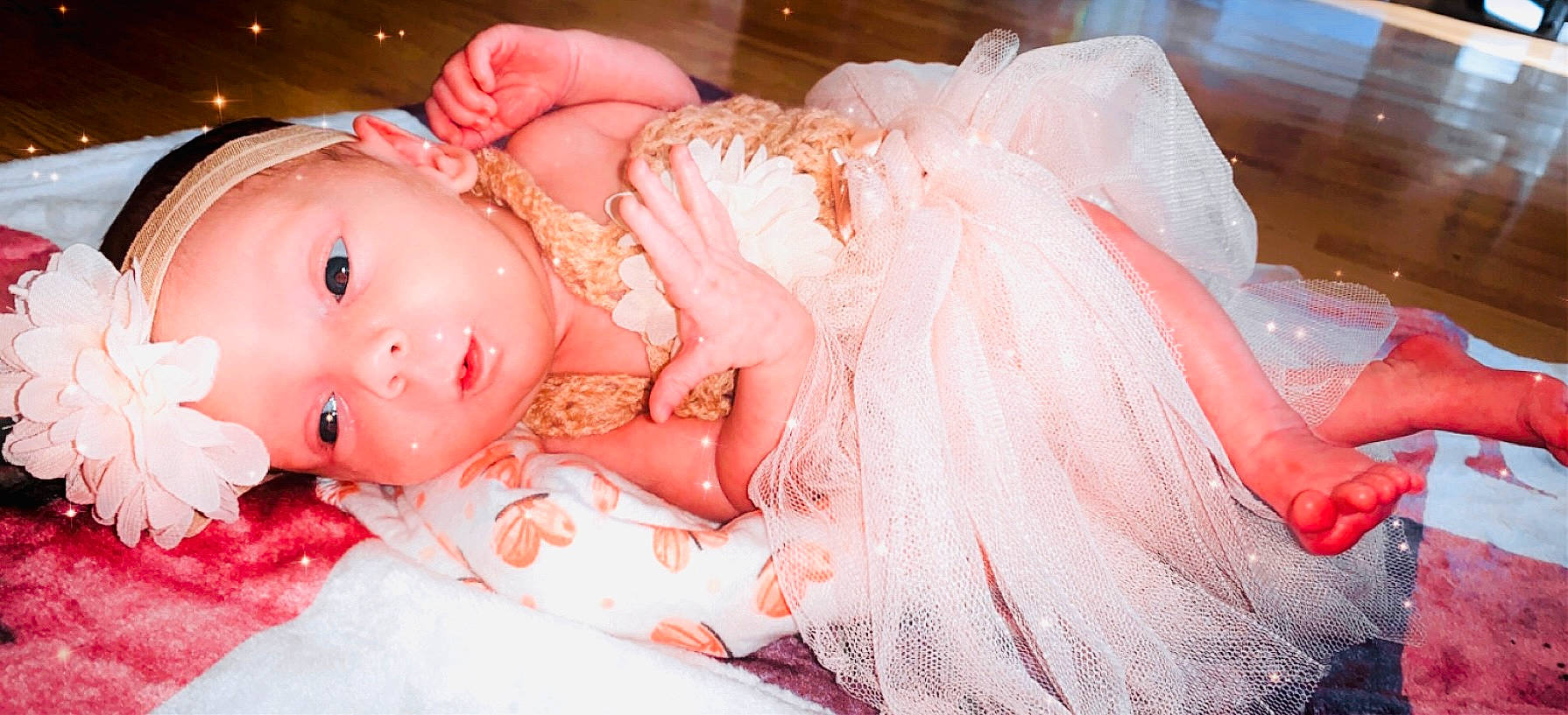 Zoee is registered to the contest to win money with this photo: baby, bridal_accessory, doll, dress, embellishment, event, eye, eyelash, fashion_accessory, fawn, headband, headgear, headpiece, headwear, iris, jewellery, pattern, peach, person, pink