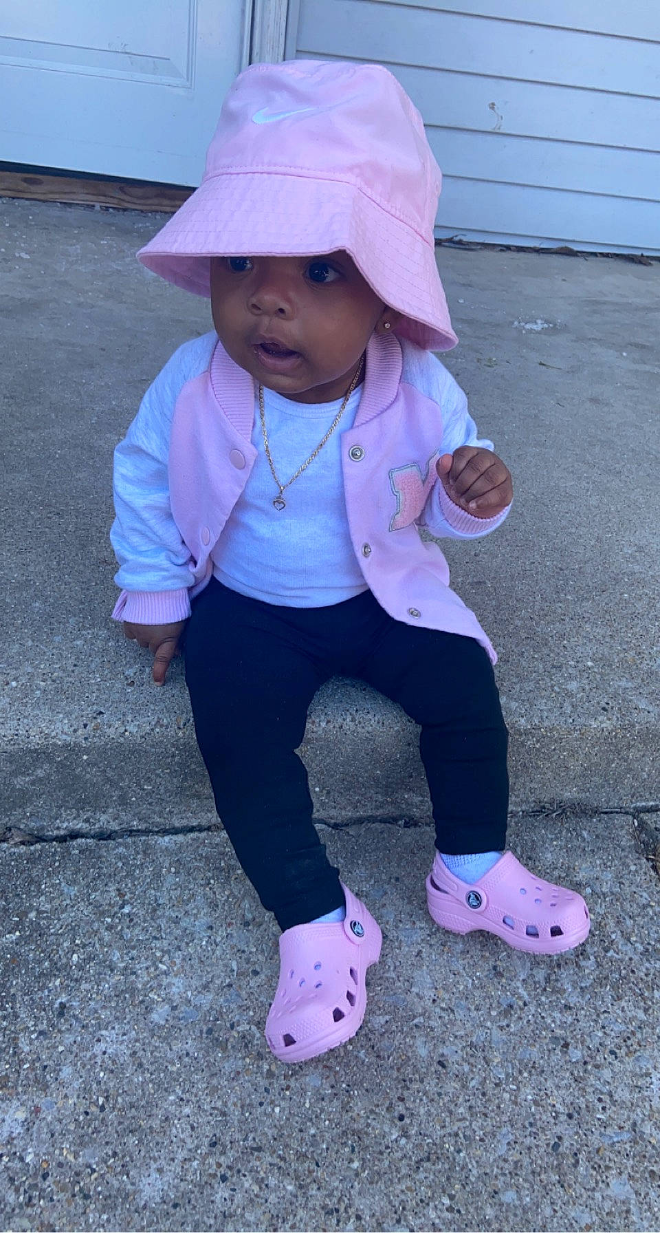 Italy is registered to the contest to win money with this photo: arm, asphalt, baby_toddler_clothing, blue, cap, clothing, electric_blue, face, hat, headwear, magenta, person, photograph, pink, purple, red, sleeve, sock, sun_hat, toddler