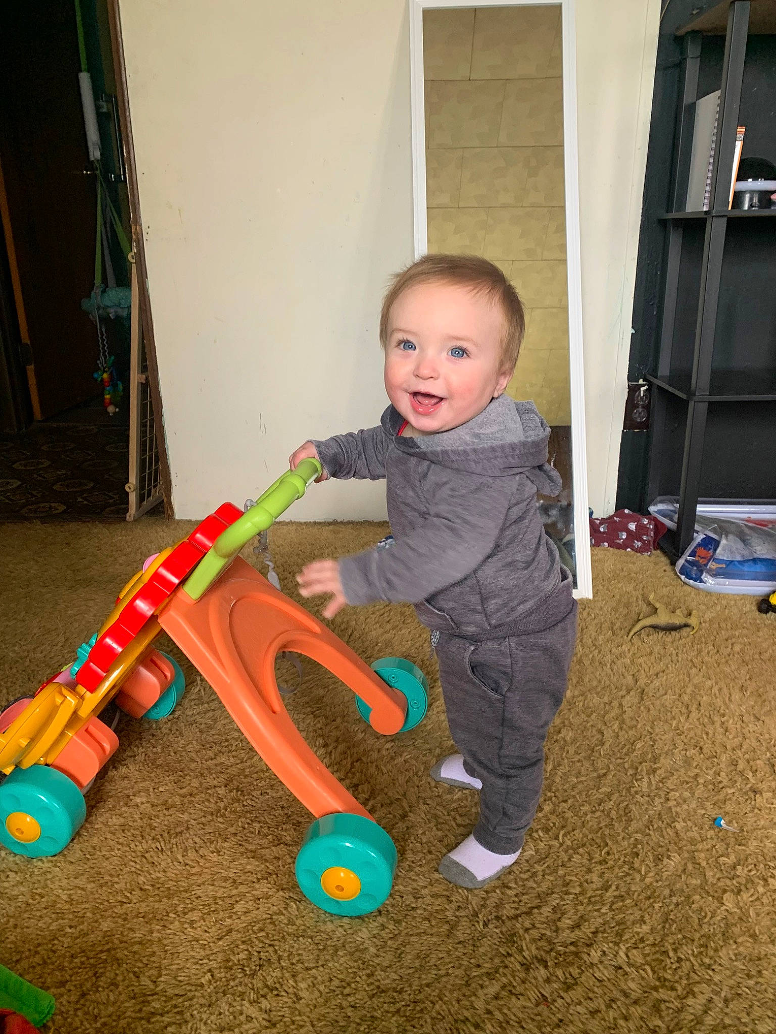 Jaxen is registered to the contest to win money with this photo: baby, baby_playing_with_toys, baby_products, baby_toddler_clothing, baby_toys, child, door, flooring, fun, hardwood, human_body, joy, leisure, musical_instrument, person, play, room, sitting, sports_toy, toddler
