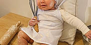Emma a rejoint le concours — aidez-le/la à gagner de superbes lots ! baby, bonnet, clothing, cooking, cream, dessert, face, food, hardwood, hat, head, icing, person, photography, plywood, portrait, powder, sitting, whisking, wood