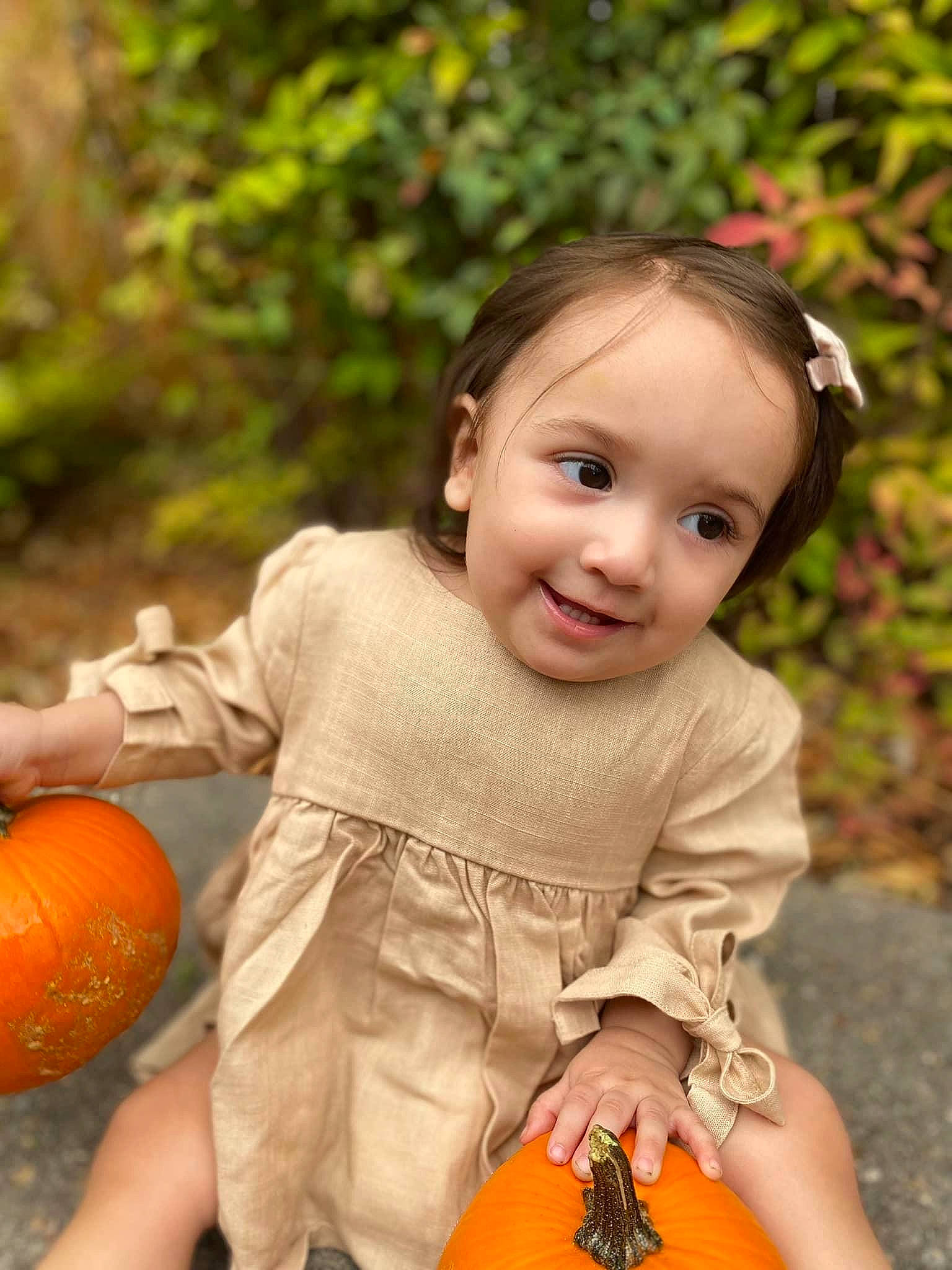 Lilah joined the competition — help win amazing prizes! baby_toddler_clothing, calabaza, cucurbita, dress, eye, facial_expression, gourd, grass, hairstyle, happy, head, joy, orange, people_in_nature, person, photograph, plant, pumpkin, smile, summer