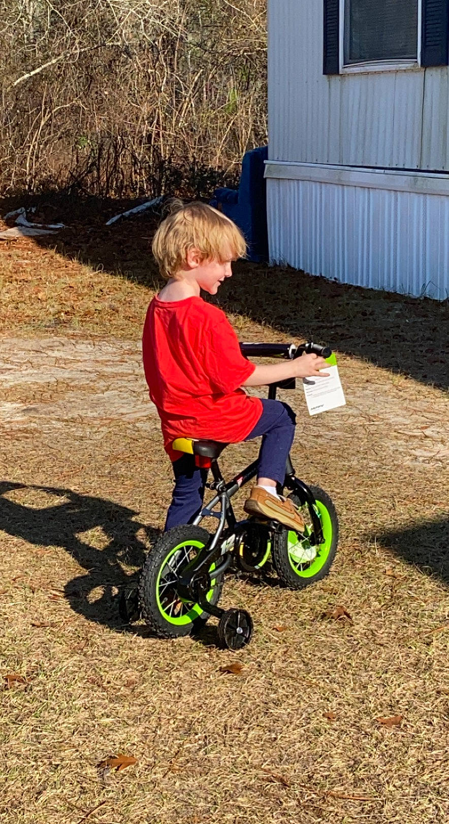 Aiden is registered to the contest to win money with this photo: automotive_tire, bicycle, bicycle_accessory, bicycle_fork, bicycle_frame, bicycle_part, bicycle_tire, bicycle_wheel, bicycle_wheel_rim, bicycles_equipment_and_supplies, footwear, grass, person, rim, rolling, sneakers, tire, toddler, tread, vehicle