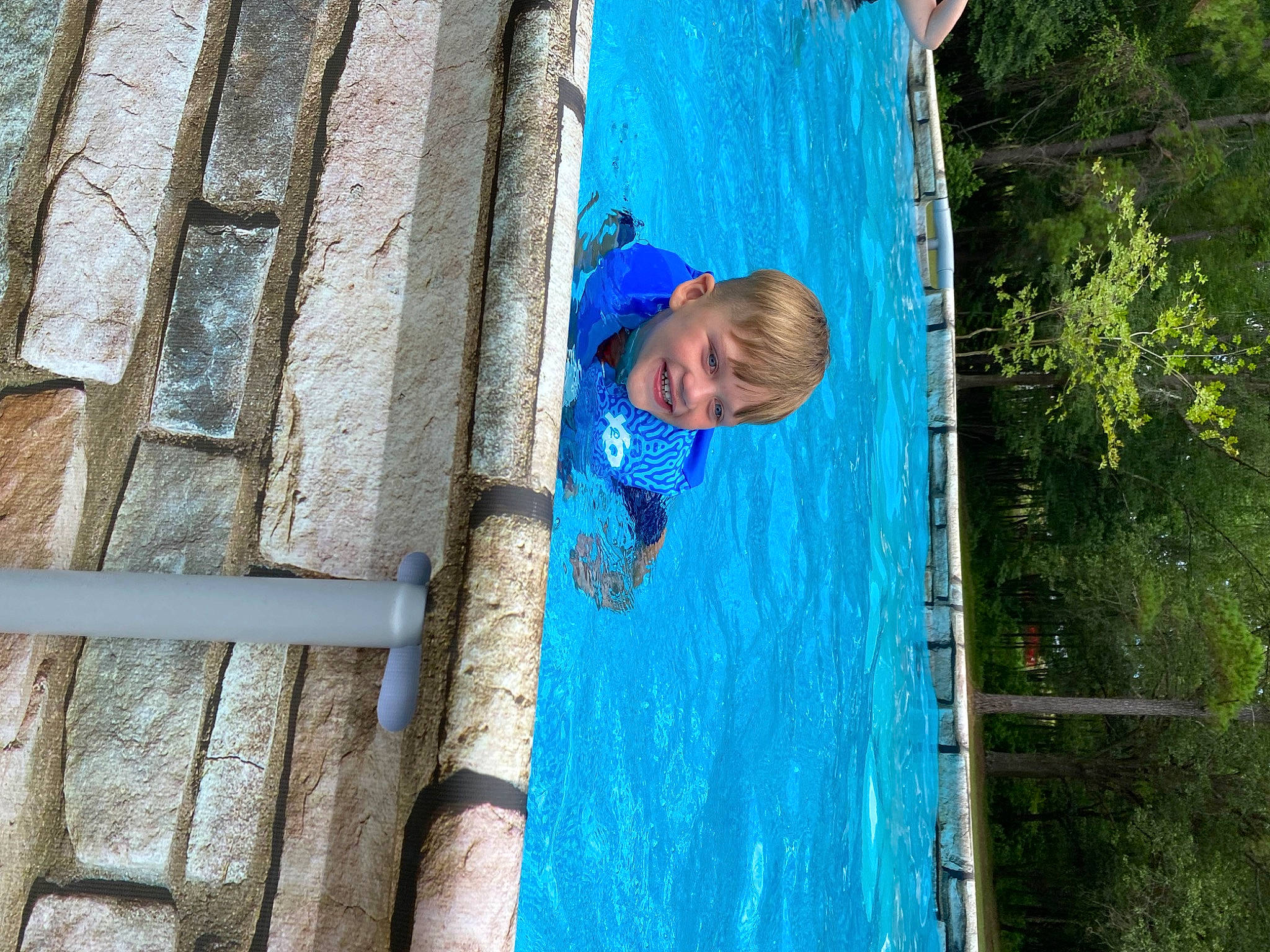 Curtis is registered to the contest to win money with this photo: adventure, azure, child, electric_blue, fun, happy, joy, leisure, person, play, recreation, smile, t_shirt, travel, tree, trunk, vacation, wall, water, wood