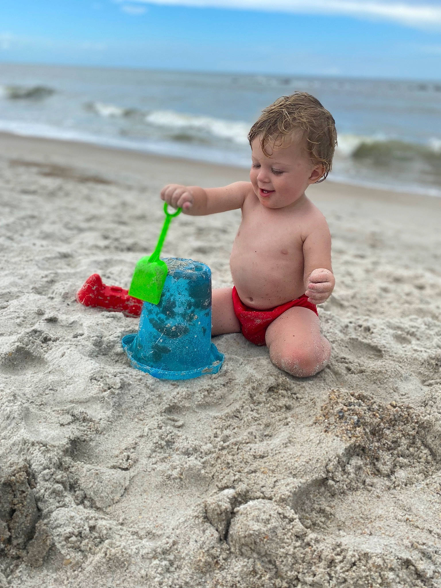 Varik is registered to the contest to win money with this photo: azure, barechested, barefoot, beach, child, cloud, fun, happy, human_leg, leg, leisure, people_in_nature, people_on_beach, person, play, recreation, shore, shorts, sky, toddler