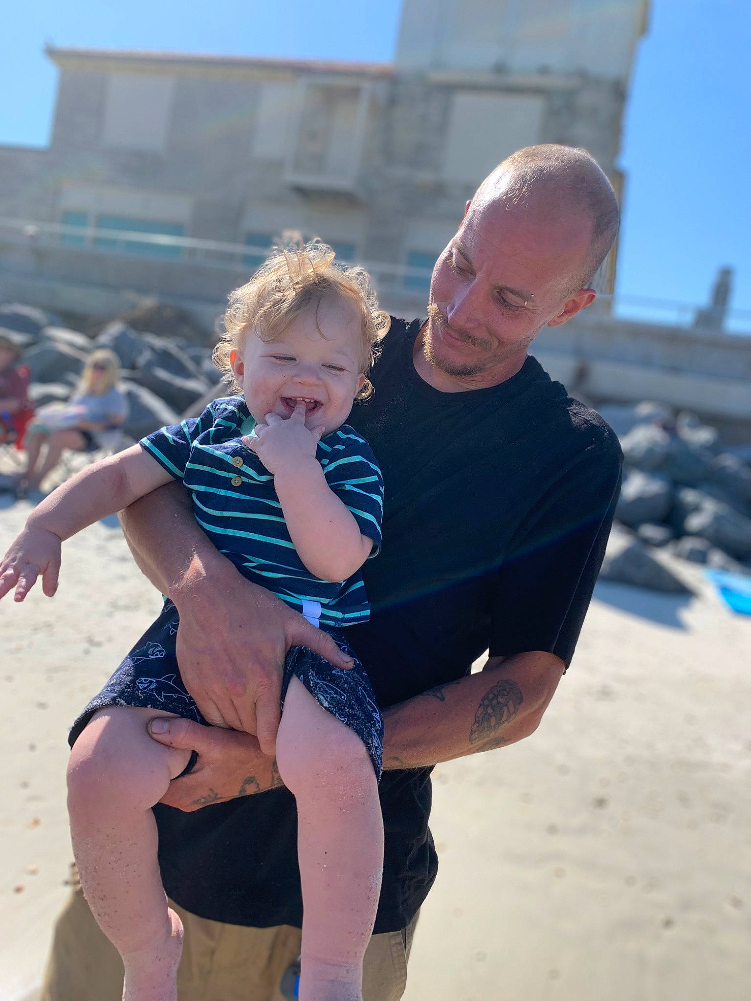 Varik is registered to the contest to win money with this photo: baby, beach, beauty, body_of_water, fun, gesture, hairstyle, happy, human, joy, leg, leisure, people_in_nature, people_on_beach, person, sky, standing, summer, sunlight, swimwear