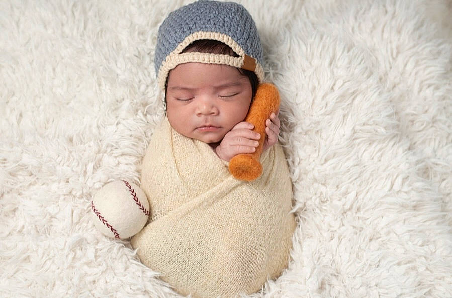 Evan is registered to the contest to win money with this photo: arm, baby, baby_sleeping, baby_toddler_clothing, beanie, bedding, bedtime, cap, comfort, flooring, fur, hand, headgear, headwear, knit_cap, linens, person, sleeve, textile, toddler