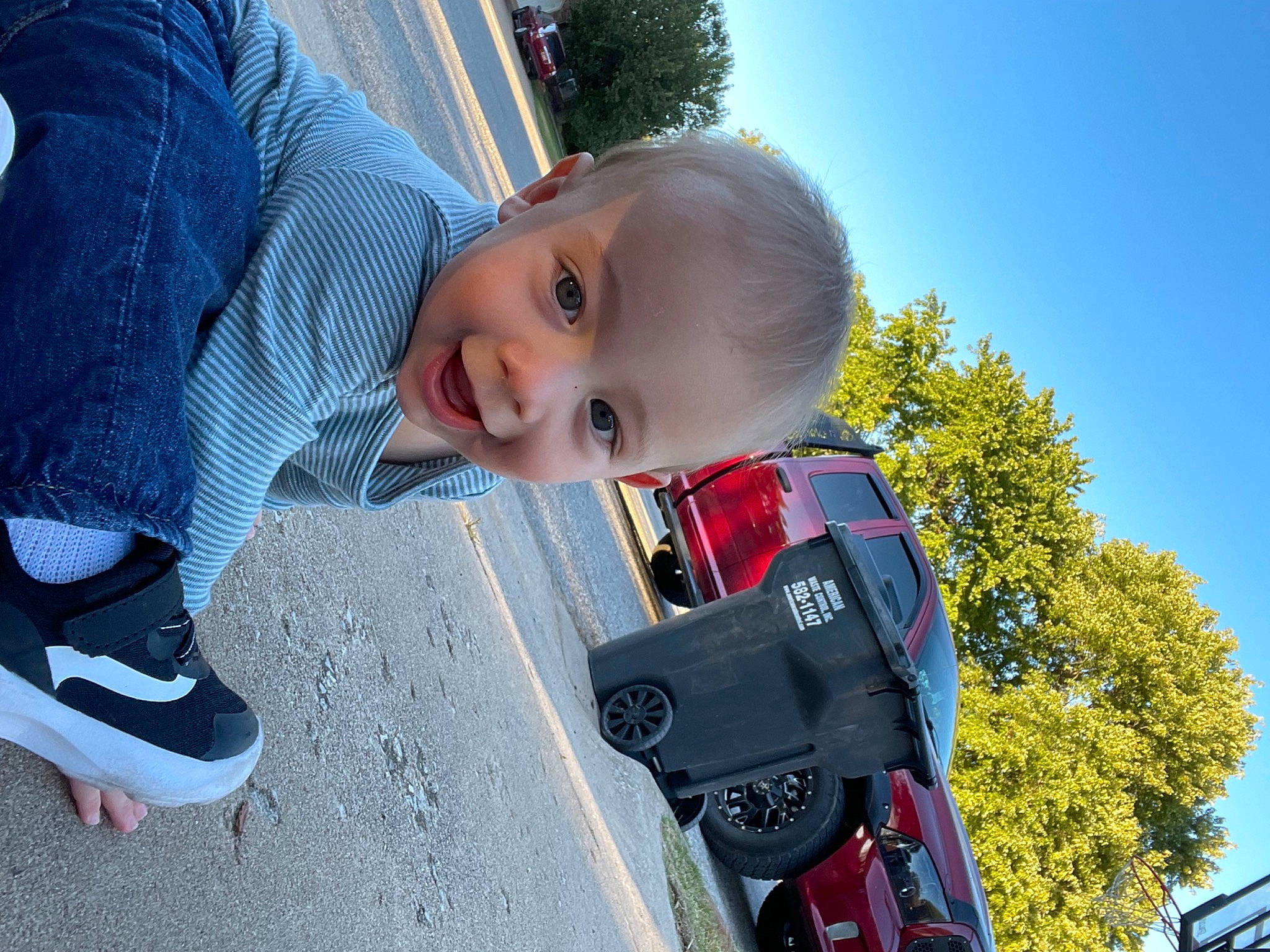 Rohan is registered to the contest to win money with this photo: asphalt, auto_part, automotive_exterior, baby, car, carmine, child, electric_blue, fun, grass, happy, leisure, motor_vehicle, person, plant, sky, smile, toddler, toy, tree