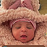 baby, bear_ears, bundle, clothing, cute, digital_overlay, face, fluffy, hand, hat, indoors, infant, newborn, notifications, phone_screen, pink, portrait, sleepy, time_display, warm