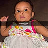baby, casual, child, colorful, couch, cute, dress, face, floral_pattern, girl, happy, indoor, infant, person, portrait, sitting, smiling, snapshot, text_overlay, young_child