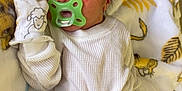Malaki joined the competition — help win amazing prizes! newborn, baby, sleeping, pacifier, blanket, mittens, animal_print, white_clothing, black_pants, infant, cute, cozy, bed, soft, resting, child, face, hand, indoor, peaceful