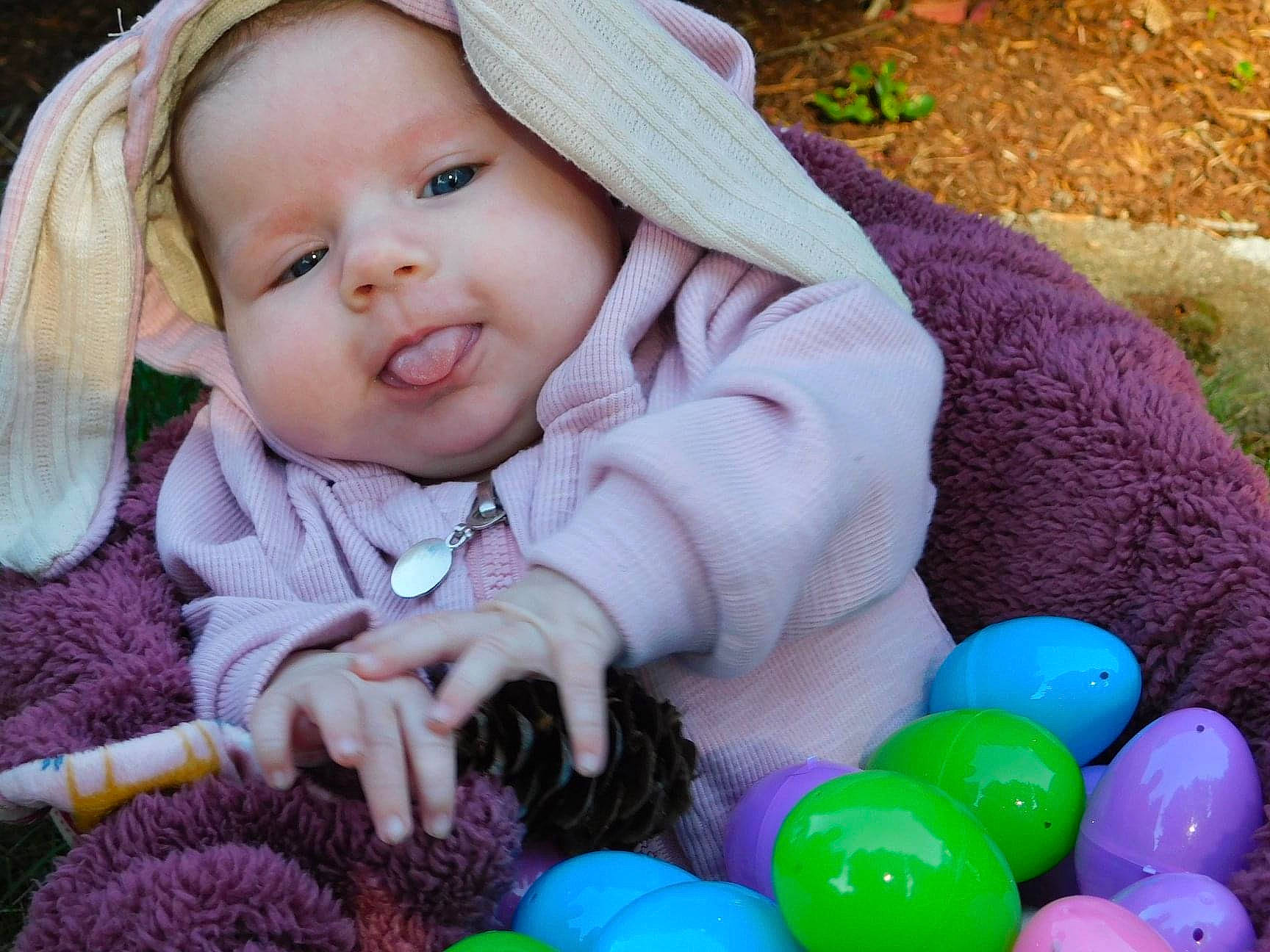 Arielle joined the competition — help win amazing prizes! baby, baby_toddler_clothing, cap, cheek, child, eye, fun, grass, green, happy, headwear, iris, mammal, people, person, photograph, pink, product, purple, skin