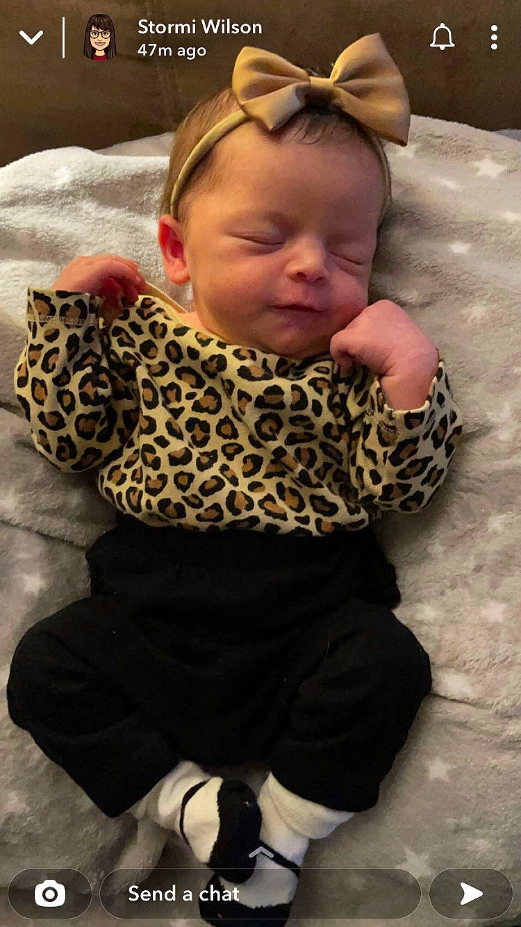 Vyvian is registered to the contest to win money with this photo: baby, baby_toddler_clothing, cheek, child, comfort, eye, face, flooring, goggles, head, headgear, neck, pattern, person, personal_protective_equipment, skin, sleeve, toddler, wood, wool