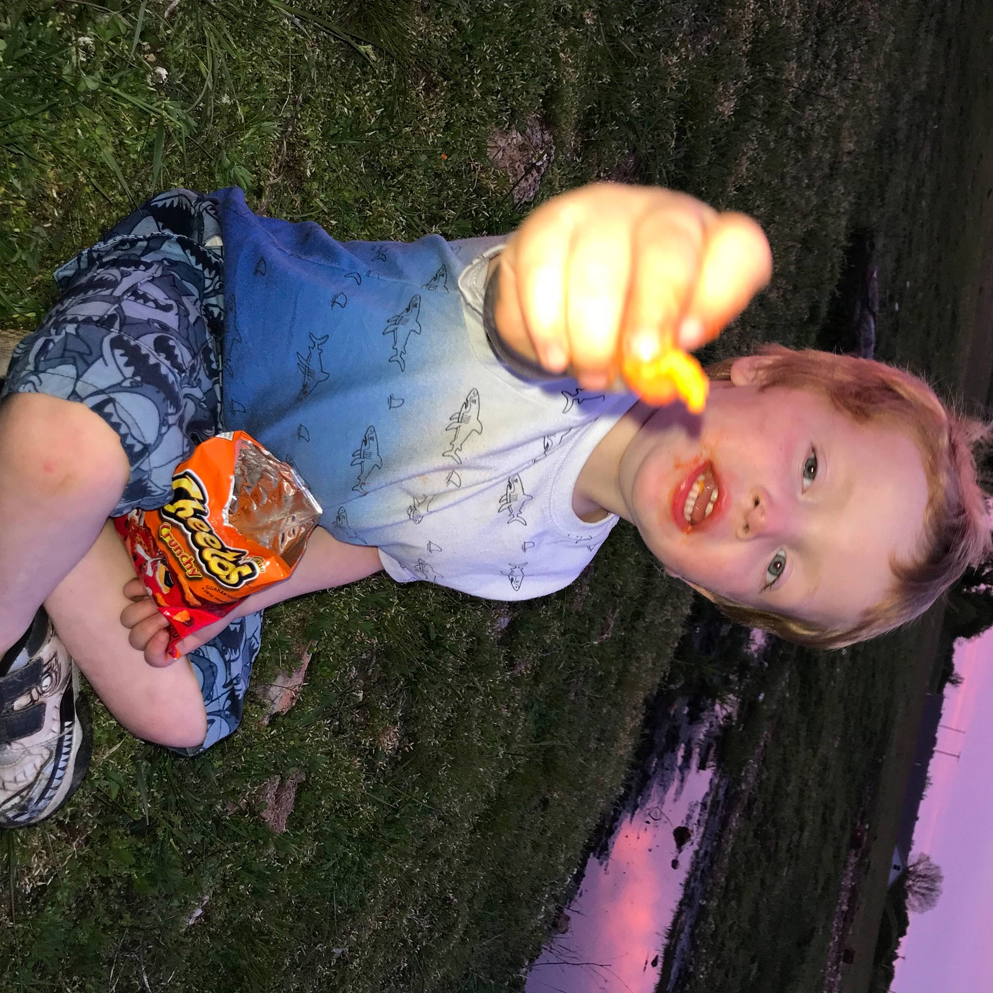 Clayton is registered to the contest to win money with this photo: child, cool, denim, elbow, finger, flash_photography, fun, gesture, grass, happy, human_leg, leisure, people_in_nature, person, plant, sitting, soil, thumb, toddler, tree