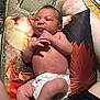Theodore is registered to the contest to win money with this photo: newborn, baby, diaper, pillow, legs, adult, skin, infant, barefoot, blanket, pattern, indoor, comfort, resting, casual, person, portrait, closeup, candid, relaxation